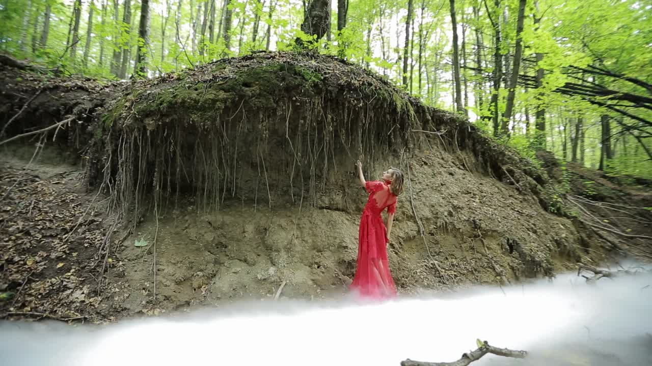 Beautiful Nymph In The Forest. Portrait of romantic woman in beautiful dress in fairy forest