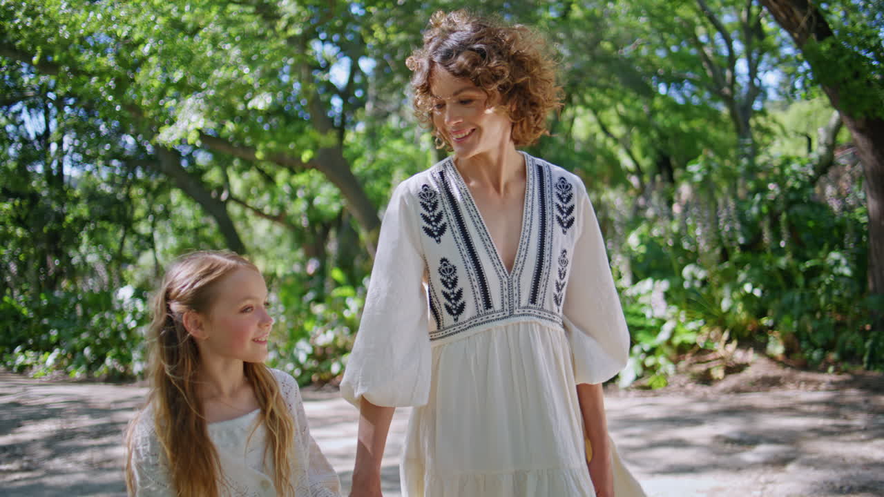 Mom kid family walk at park closeup. Happy relaxed woman girl enjoy holiday
