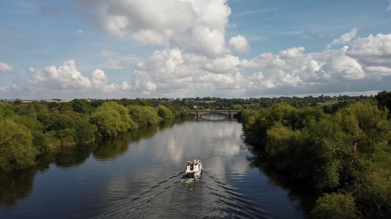 Drone aerial video of a River Boat sailing along the River Trent towards a bridge in Nottinghamshire