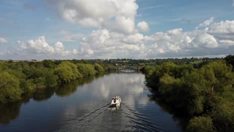 drone aerial video of a river boat sailing along the river trent towards a bridge in nottinghamshire