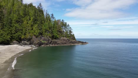 A-Beach-at-Moresby-Island-with-Tall-Green-Trees-Along-the-Coastline