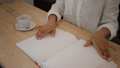 blind woman sitting on table desk and drinking