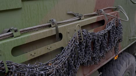 8x8 military transport vehicle with chains in downtown riga, close up view