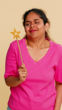 indian woman holding imaginary magic wand making enchanting gestures playfully performing trick