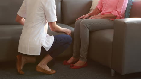 nurse doing hand massage to her senior patient