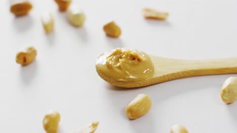 Video-of-close-up-of-peanut-butter-on-white-background