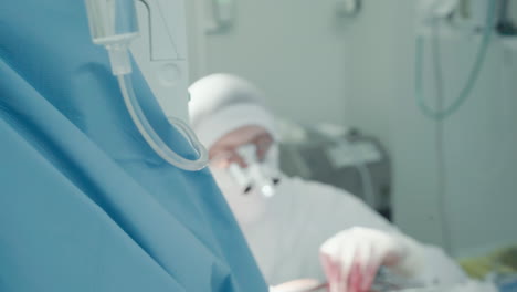 doctor operates with assistant aid. i.v. against surgeon performing artery bypass surgery supported by nursing staff in hospital operating room