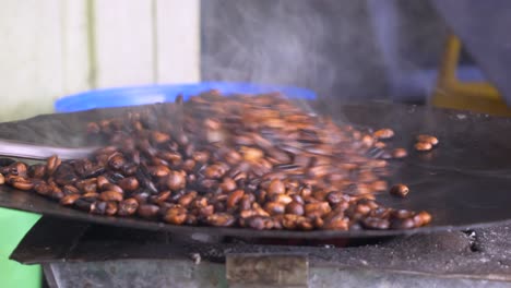 bunna seller is roasting the coffee beans in her small traditional shop, in addis ababa in ethiopia