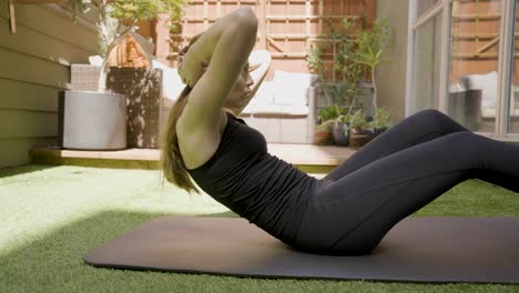 a white woman doing sit ups in her back yard