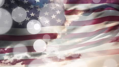 Animation-of-waving-usa-flag-and-glowing-spots-over-cloudy-sky