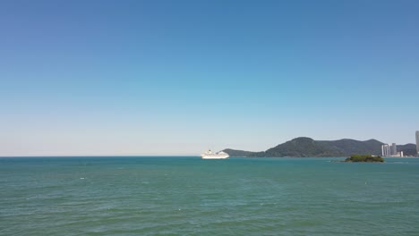 Cruise-ship-on-the-ocean-departing-from-coastal-city