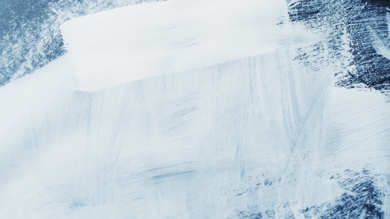 Close up of white paint shapes on black background with copy space, slow motion