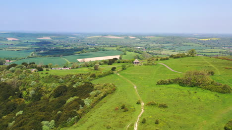 Aerial-wide-flying-towards-Butser-Hill-Sunny-day-UK-4K