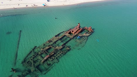 Aerial-shot-by-drone-of-a-shipwrecked-ship-very-close-to-a-beach-in-Epanomi,-Thessaloniki-in-Greece