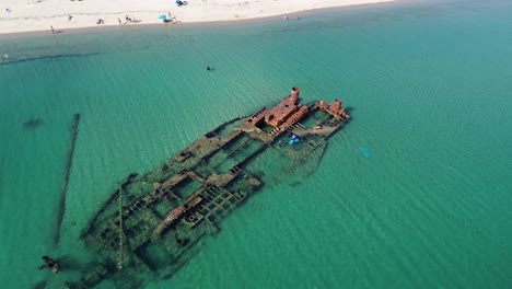 aerial shot by drone of a shipwrecked ship very close to a beach in epanomi, thessaloniki in greece