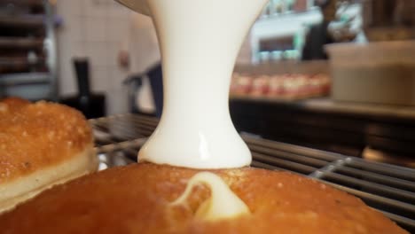 Cookies-and-cream-donut-being-covered-with-white-cholote-close-up-macro-filmed-with-Laowa-24-probe-lens