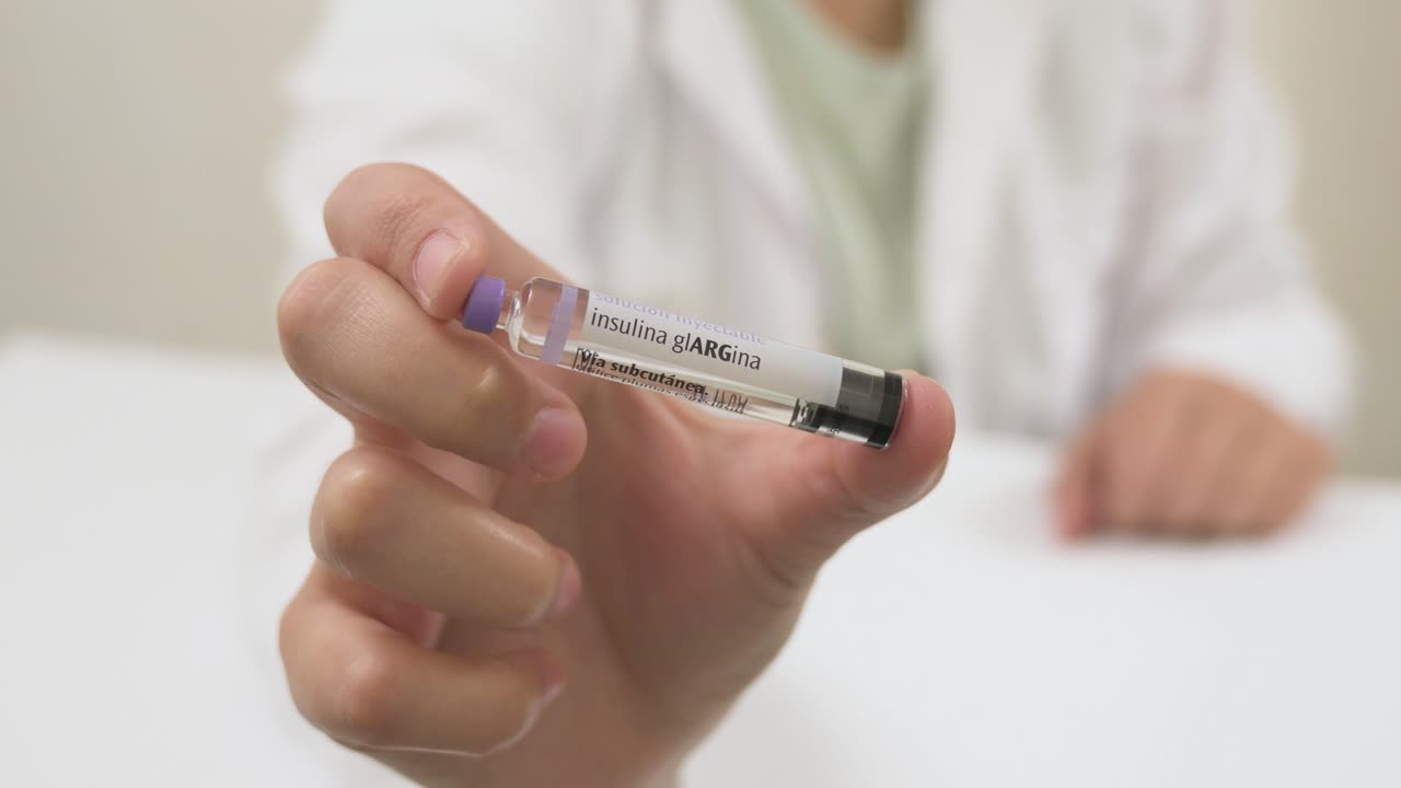 Medical professional showing a cartridge of long acting insulin for subcutaneous injection
