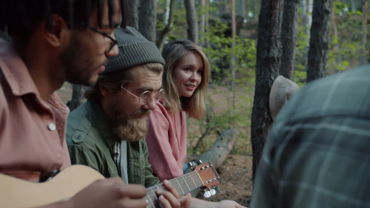 Friends Playing Guitar in the Forest