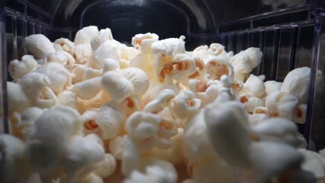 close up shot of jumping popcorn's during production process in cinema,slow motion