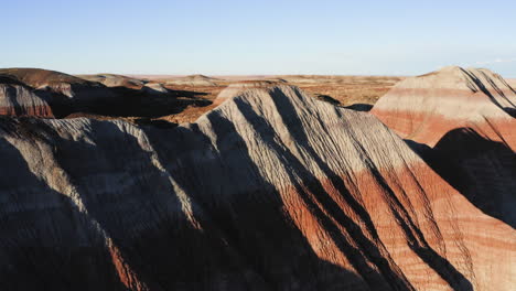 Teepees-of-Painted-Desert-with-blue-sky-at-Arizona---aerial-drone-flying-shot