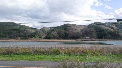 passing by a tranquil lake and mountainside landscape