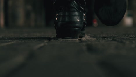 extreme close up of persons legs in boots walking
