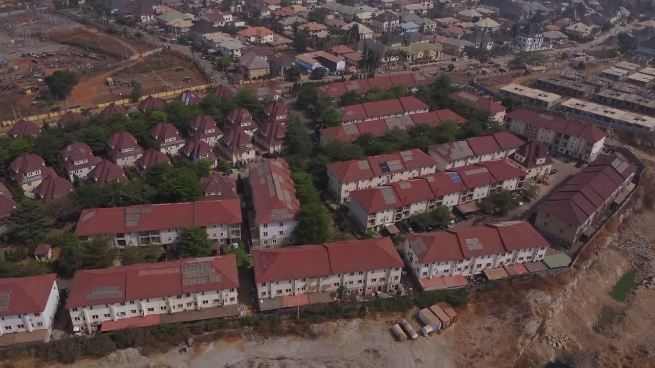 High angle view of a peaceful suburban neighborhood with green trees standing in between rows of houses in Abuja, Nigeria