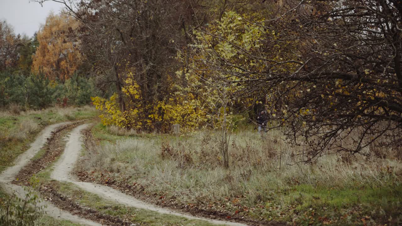 Walking male backpacker tourist. Travel and healthy lifestyle outdoors in fall season nature