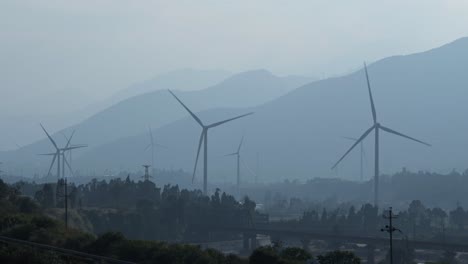 a large chinese windfarm located in the valley of sichuan located in between traditional chinese farms