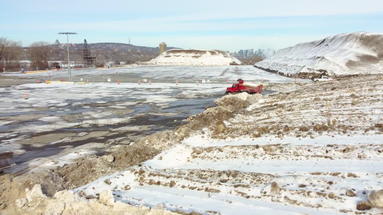 Red Winter Service Vehicle Dumping Snow After Removal Near Bulldozer