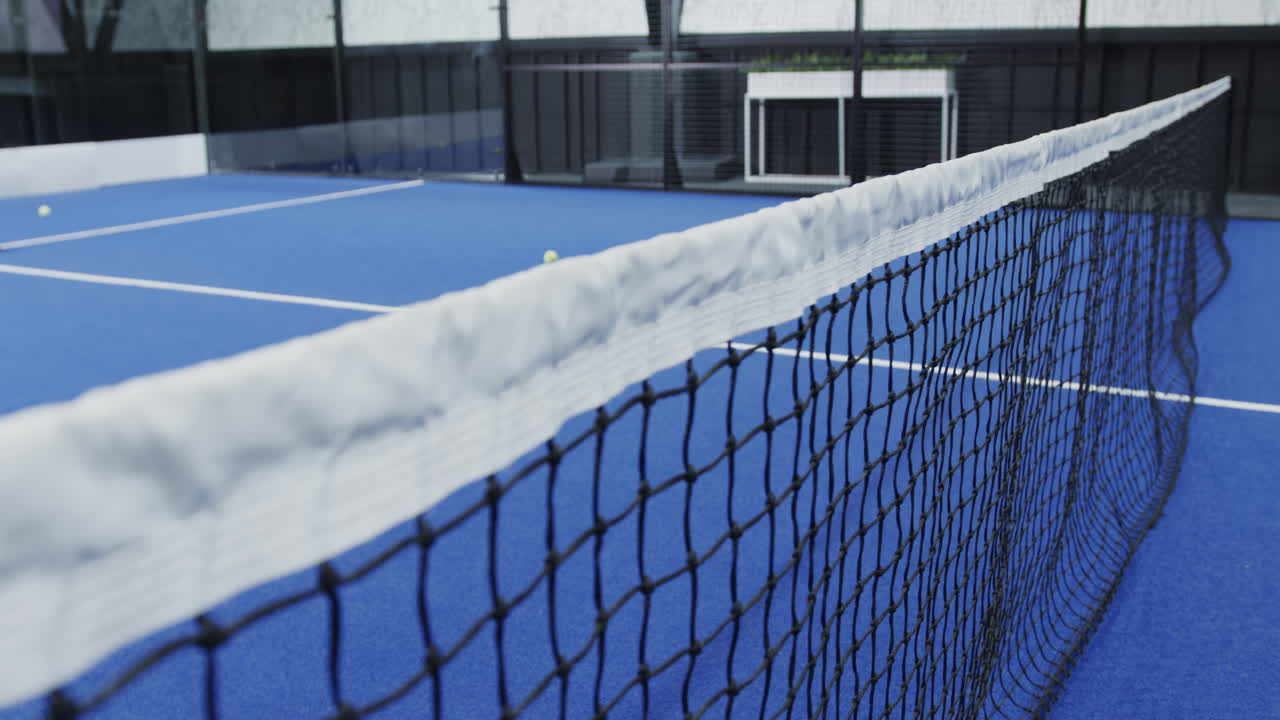 Padel tennis court with net and ball, ready for exciting match