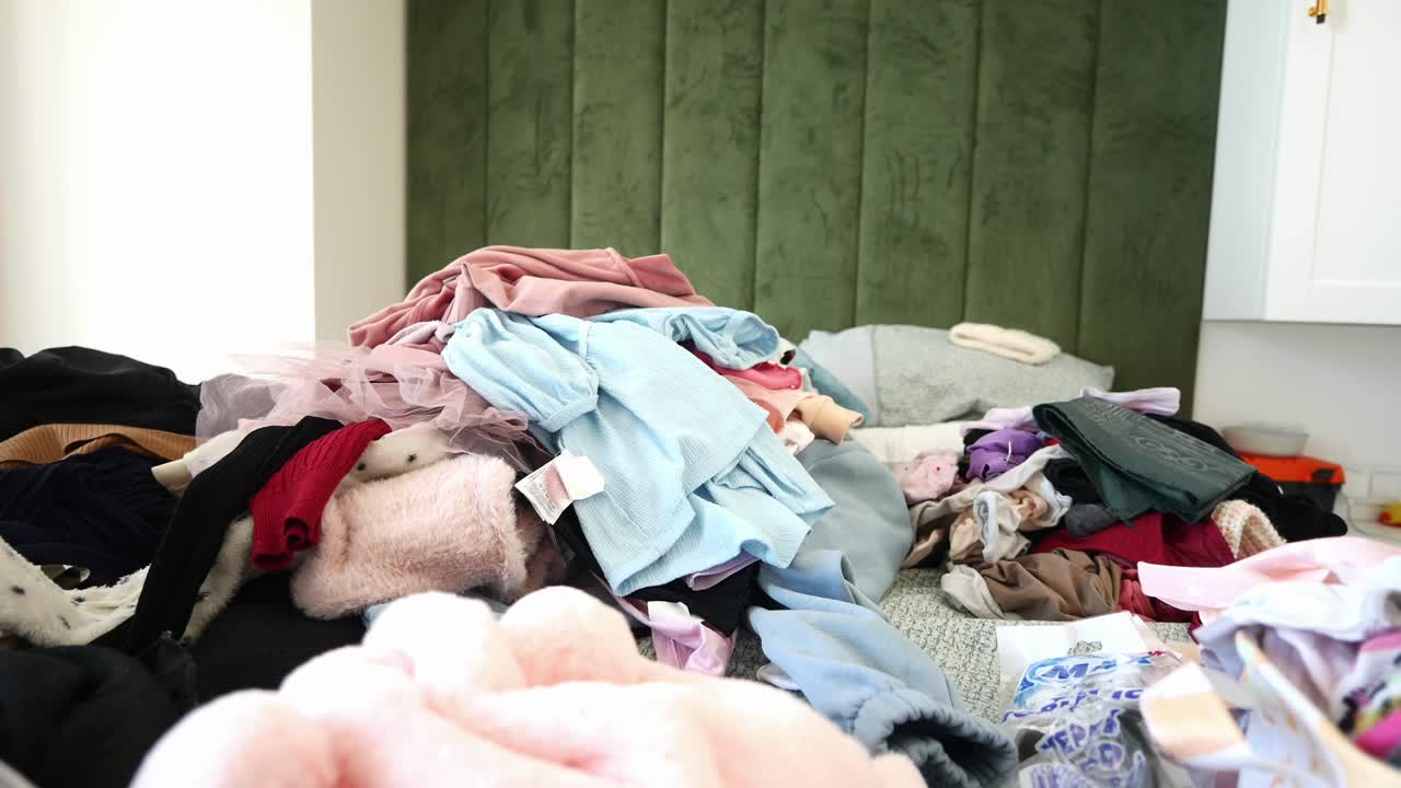 A Messy Bedroom with Clothes Pile