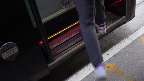 woman stepping onto the tram and public transport infrastructure