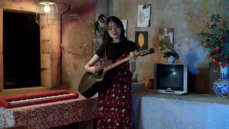 cute asian woman singing and playing guitar at home, vintage home decor and interiors, medium shot