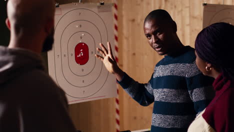 shooting range safety officer explaining bullseye scoring system to people