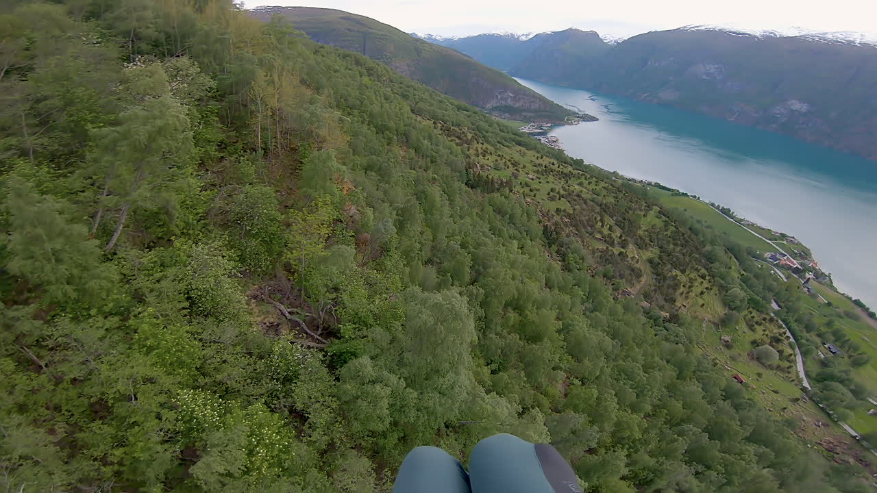 Speedflying down a mountain in Aurland in Norway. Speedfying is a small paraglider wing. This is a POV shot of the flight.