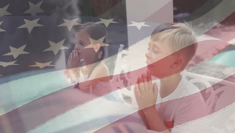 animation of american flag over caucasian family having dinner and praying