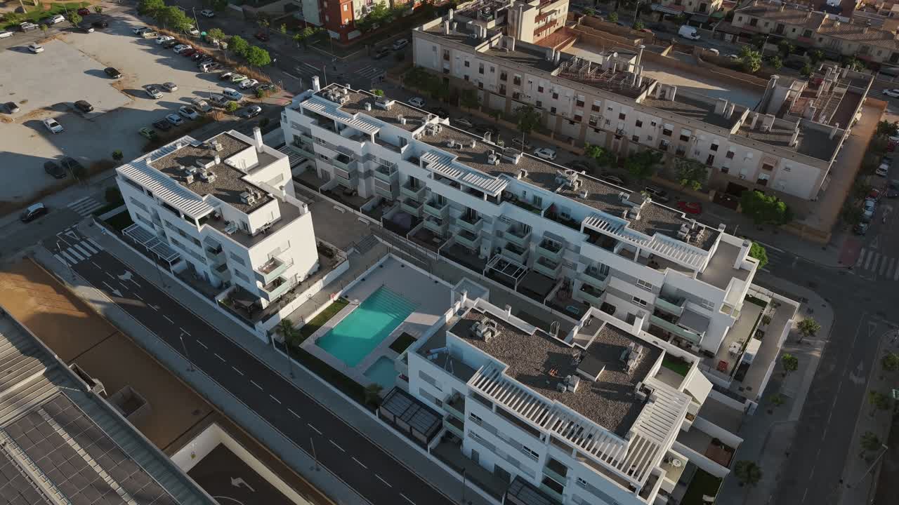 Aerial view of modern residential buildings with swimming pool in Málaga, Spain, on a sunny day