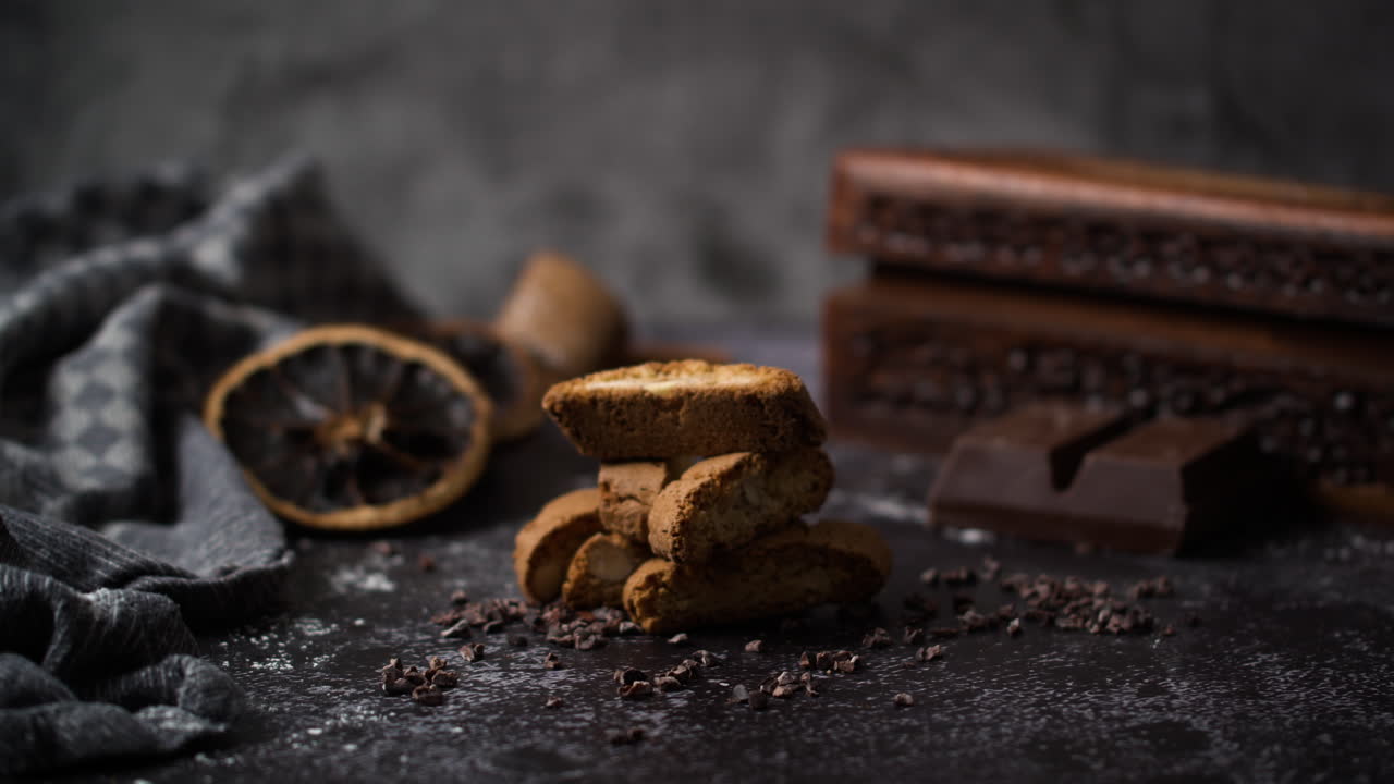 mujer decorando pan de jengibre con almendras en un fondo oscuro de otoño