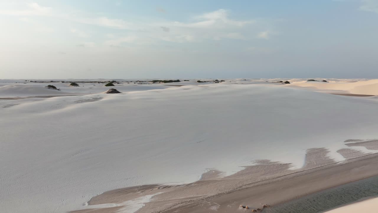 Aerial: sand dunes in Lencois Maranhenses National Park during the day in Maranhao state, northeastern Brazil, establishing drone shot