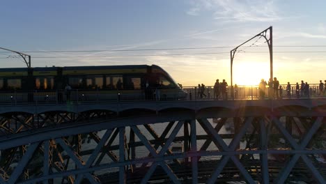 train in bridge over river douro porto at sunset portugal aerial view