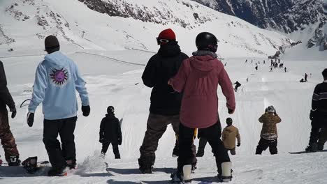 Freestyle-youth-in-Hintertux-snowpark-on-snowboards-in-Austrian-Alps,-Tyrol