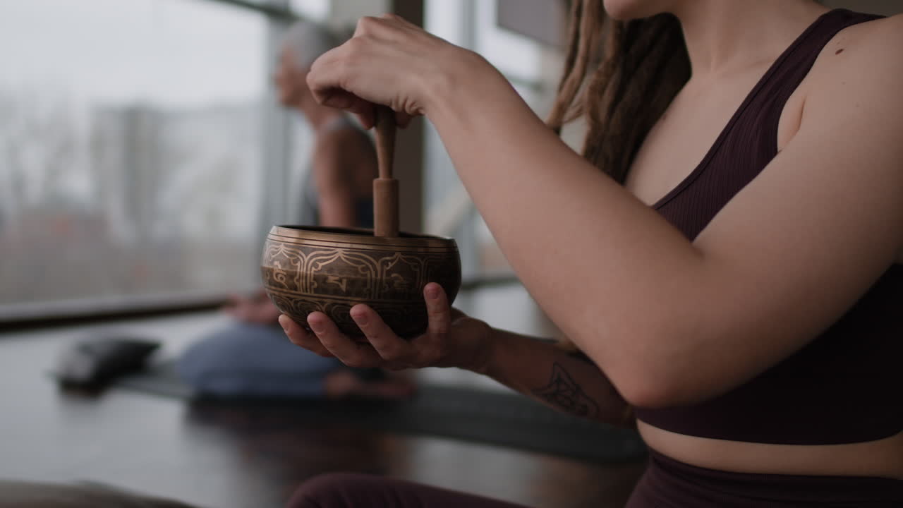 Woman meditating with singing bowl