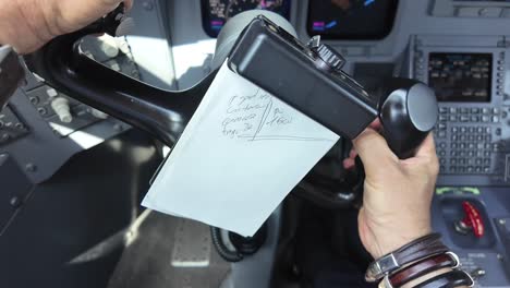 Close-up-view-of-the-hands-of-a-caucasian-pilot-handling-the-flight-wheel-of-a-jet