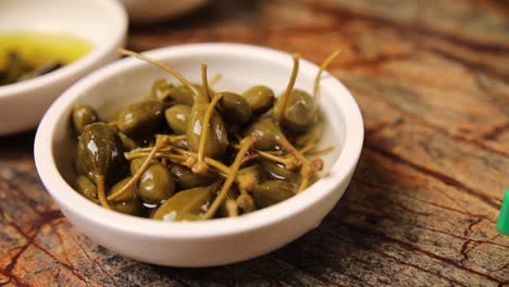capers in a small white bowl