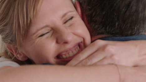 happy couple hugging excited woman embracing boyfriend sharing good news enjoying romantic relationship at home