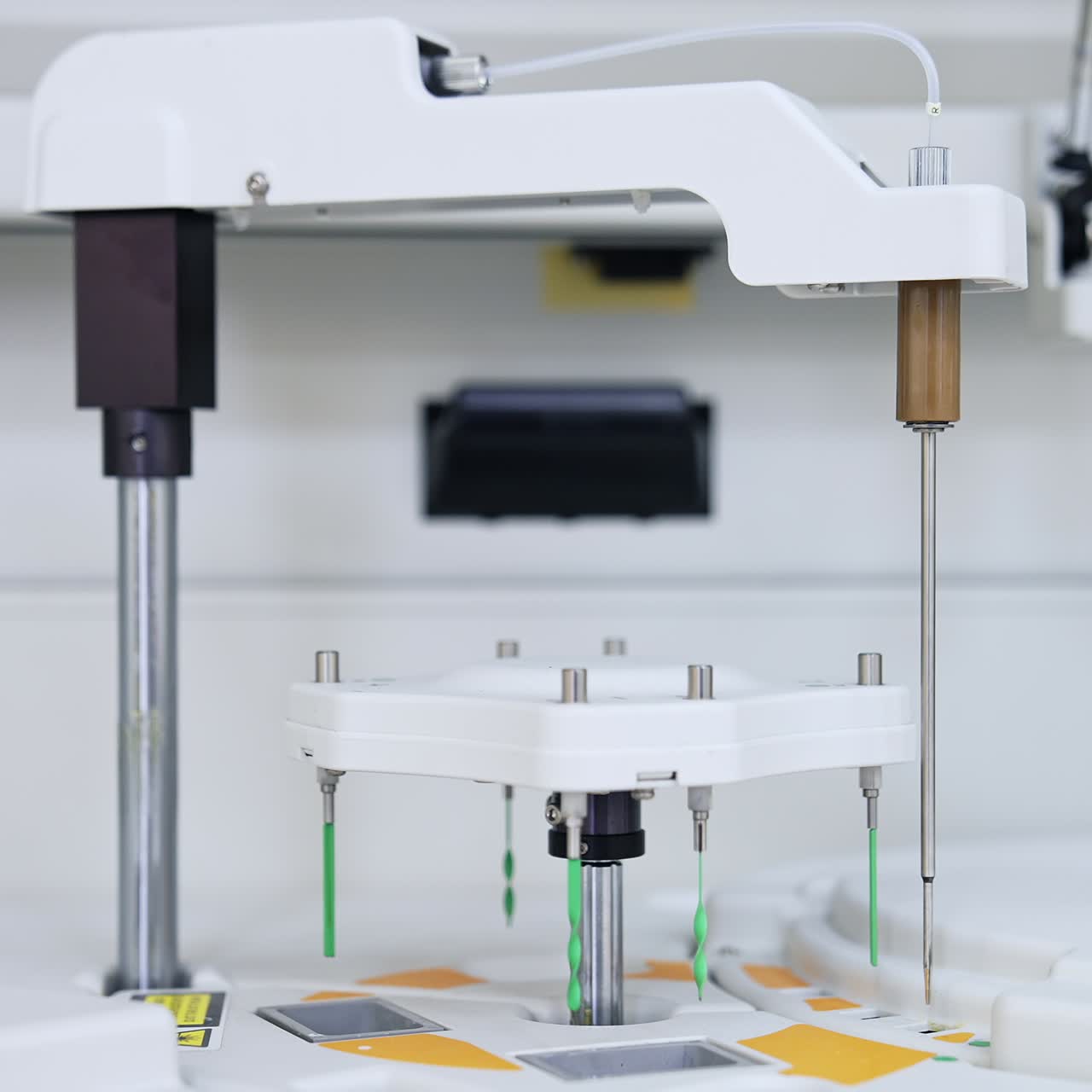 Machine detail is moving lowering and going up. Advanced equipment performing science medical analysis and testing. Close up. Blurred backdrop