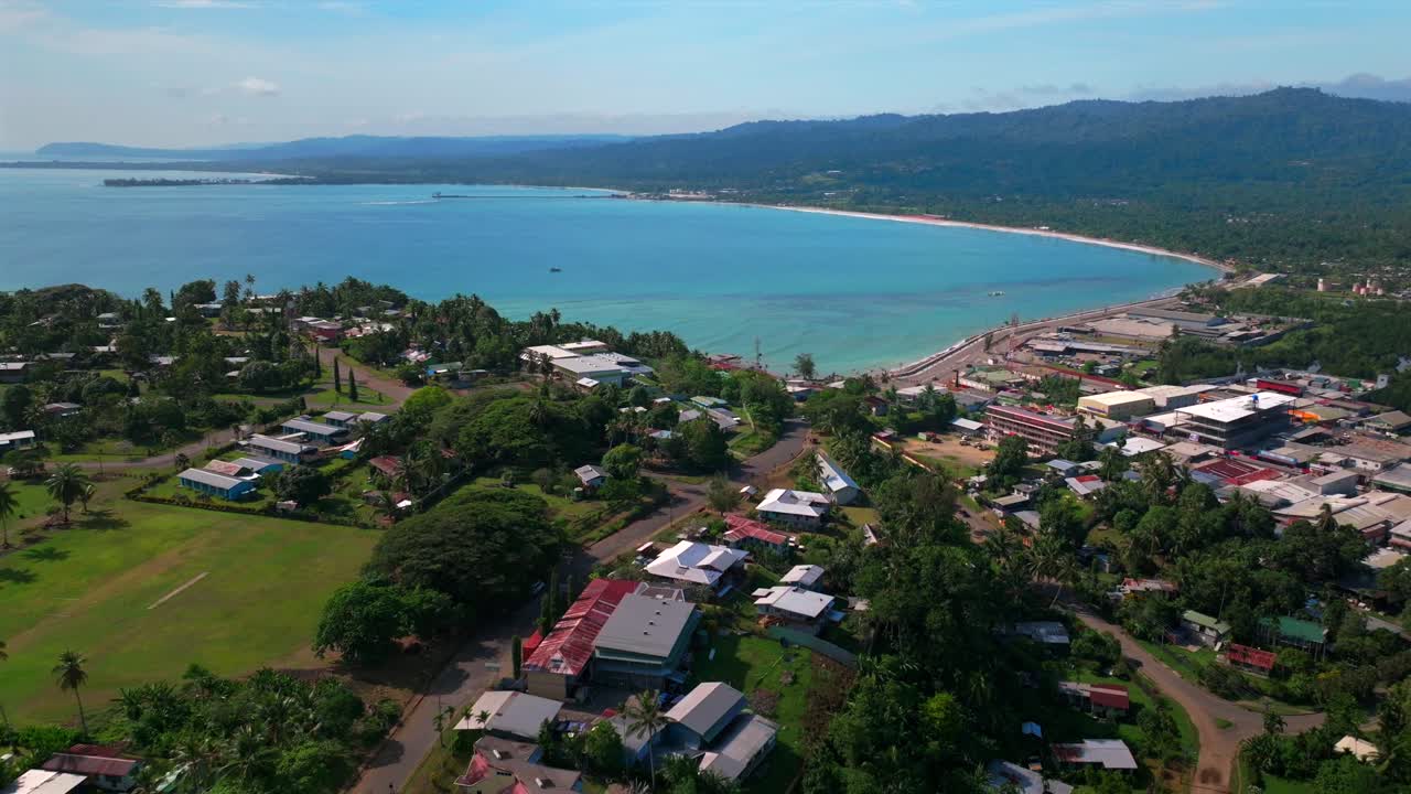 Sunny morning Wewak Papua New Guinea aerial drone dry season Boram Road Wewak Hill costal town Wewak Seawall memorial drive Mini Beach Dogreto Bay shipwreck Sundaun Market backwards pan up motion