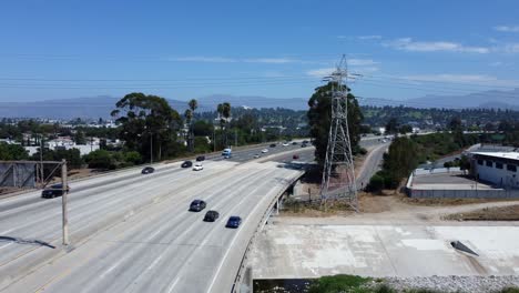 Drone-shot-flying-over-busy-freeway-in-America-on-hot-summer-day