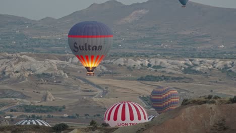 high angle view of hot air balloons rising into sky, cappadocia, turkey